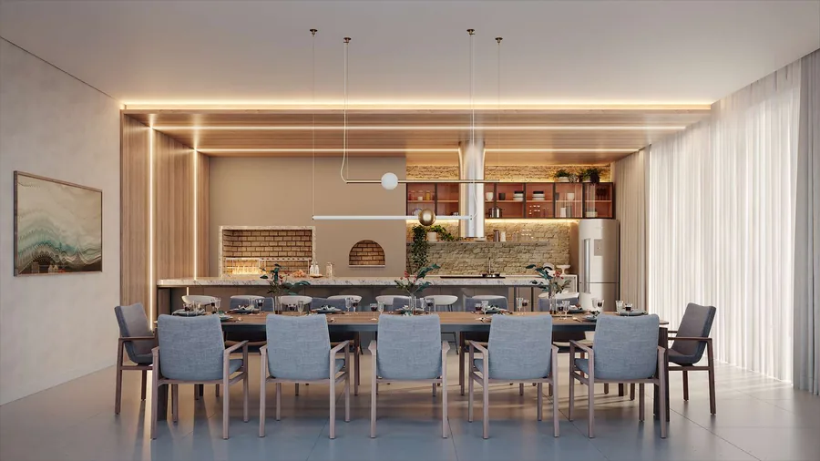 Espaço gourmet com mesa longa para doze lugares, bancada de preparo e forno de alvenaria ao fundo