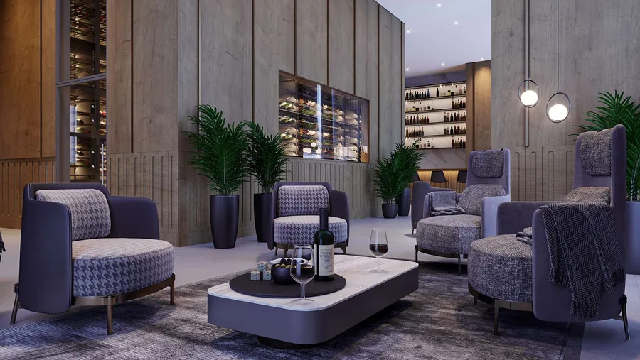 Wine bar com poltronas estampadas, mesa baixa de pedra e prateleiras de vinho na parede de concreto