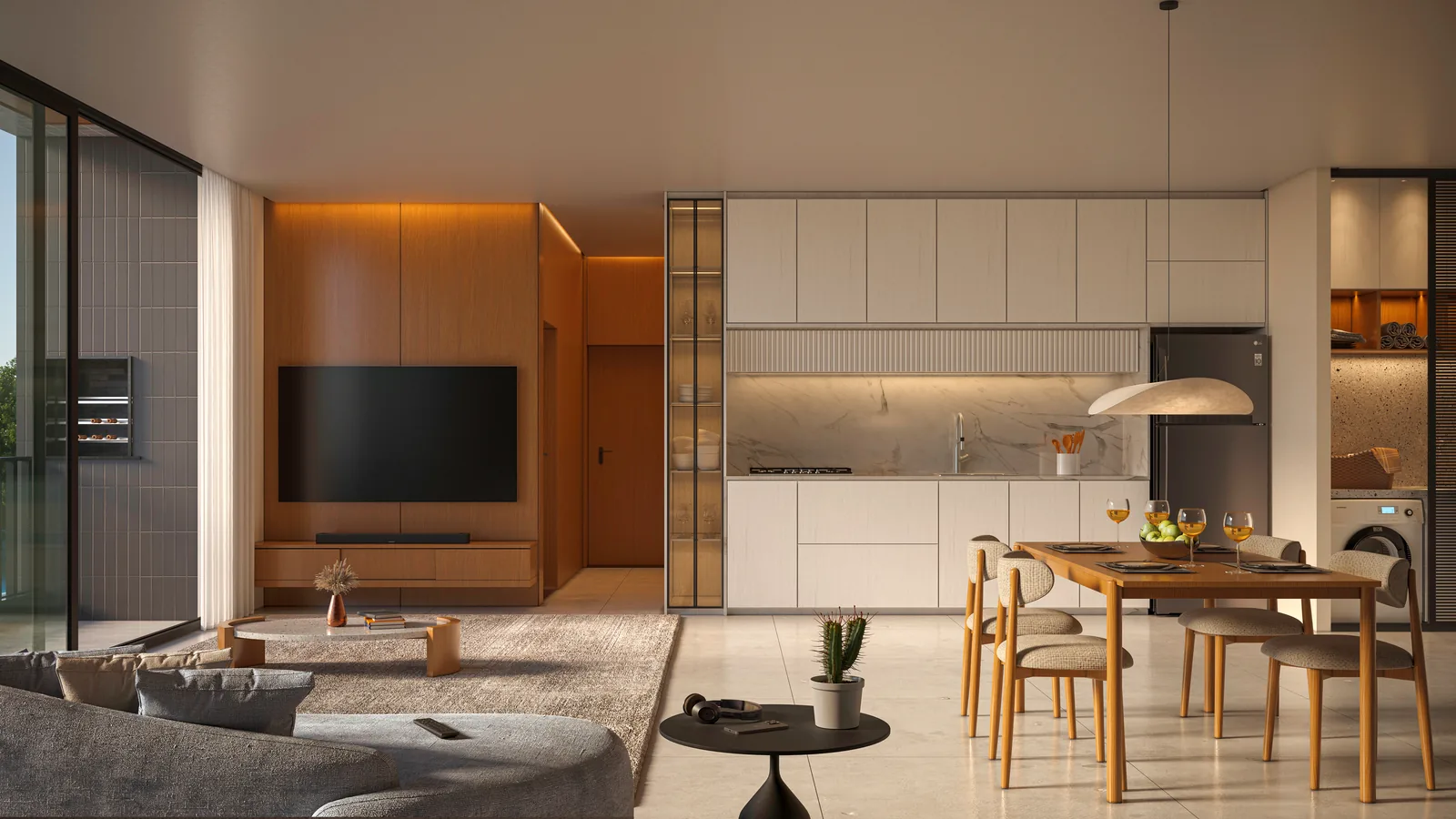 Living do apartamento tipo, com sofá claro, painel de televisão em madeira, mesa de jantar redonda e a cozinha aberta no mesmo vão