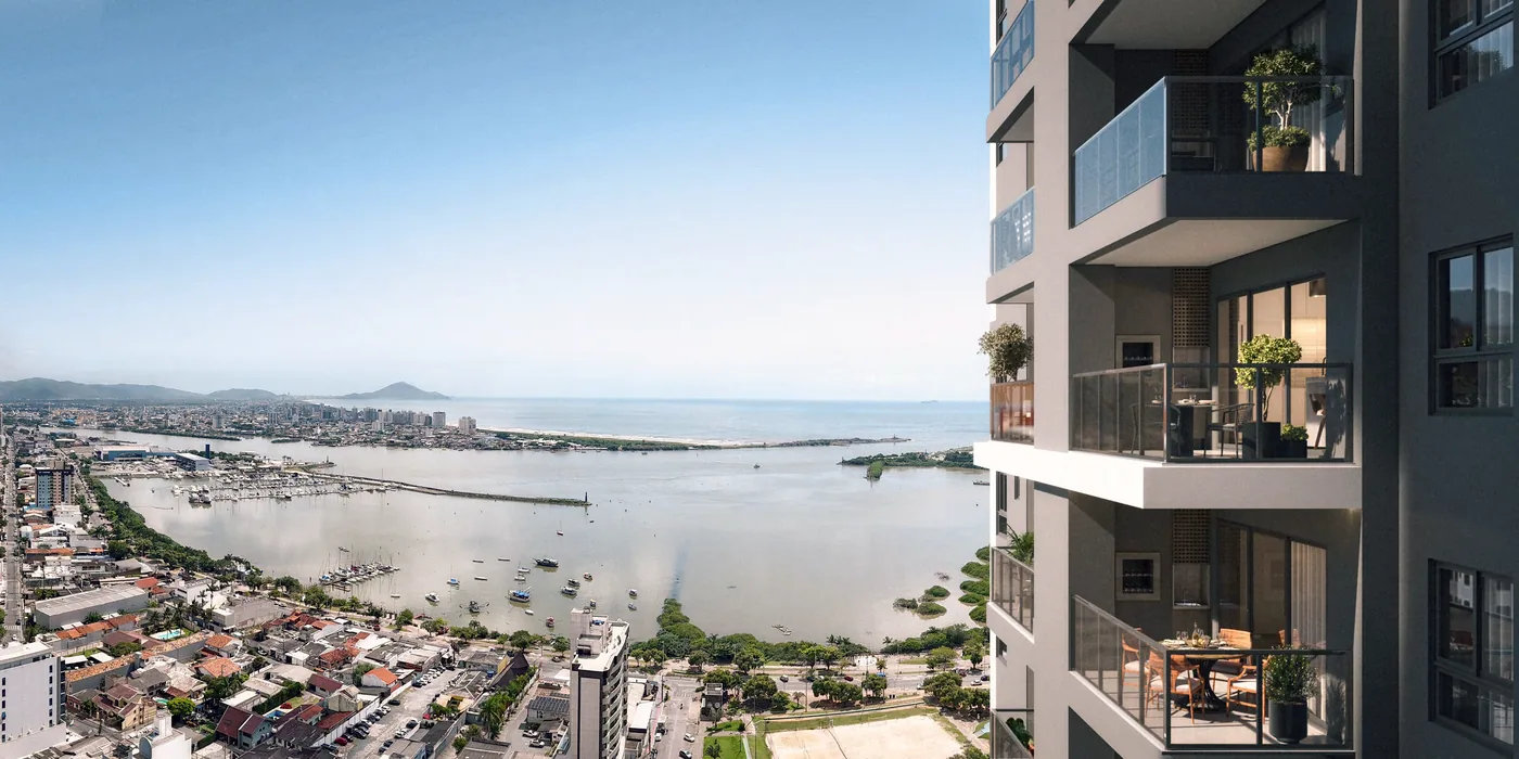 Vista de uma varanda alta sobre o bairro, com o rio Itajaí-Açu, o porto e o mar ao fundo