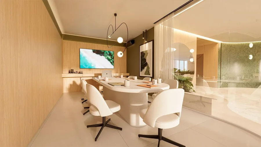 Sala business com mesa de reunião branca, cadeiras giratórias e televisão na parede
