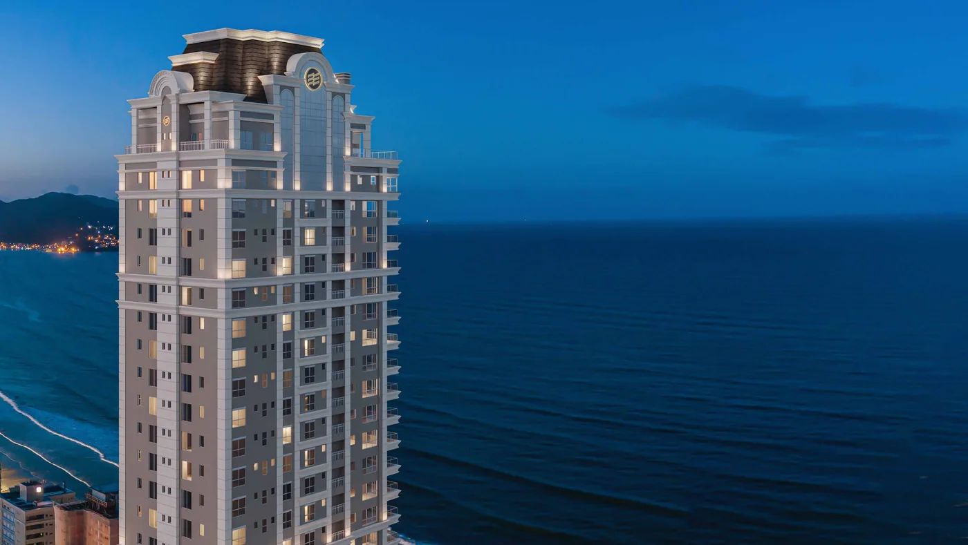 Coroamento da torre do L'Atelier em detalhe, com arcadas e cúpula recortadas contra o mar aberto
