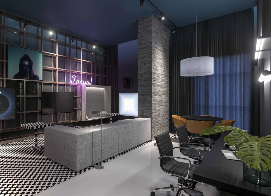 Coworking do edifício, com estações de trabalho, poltronas e jogos eletrônicos