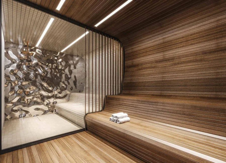 Sauna revestida em madeira, com bancos corridos e iluminação indireta