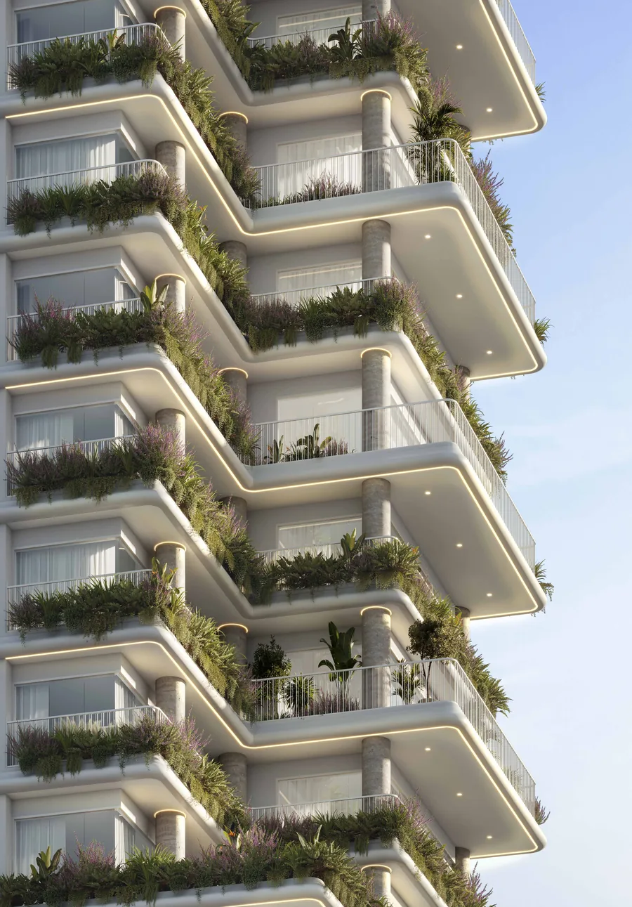 Detalhe da fachada do Velta, com sacadas em curva empilhadas e plantas pendentes cobrindo a borda de cada laje