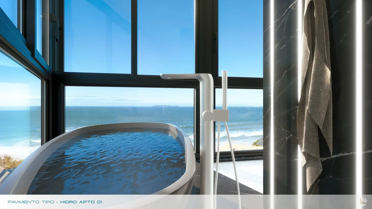 Hidromassagem do apartamento tipo, junto à janela do piso ao teto, com o mar ao fundo