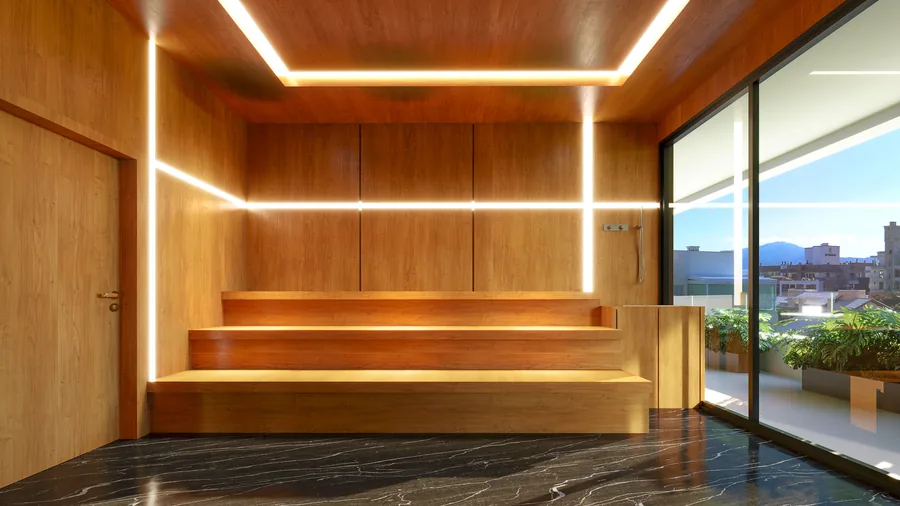 Sauna revestida em madeira, com bancos em degraus e iluminação linear embutida