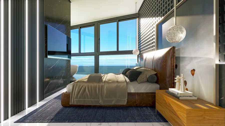 Suíte do apartamento tipo, com cama de casal, marcenaria clara e janela para o mar