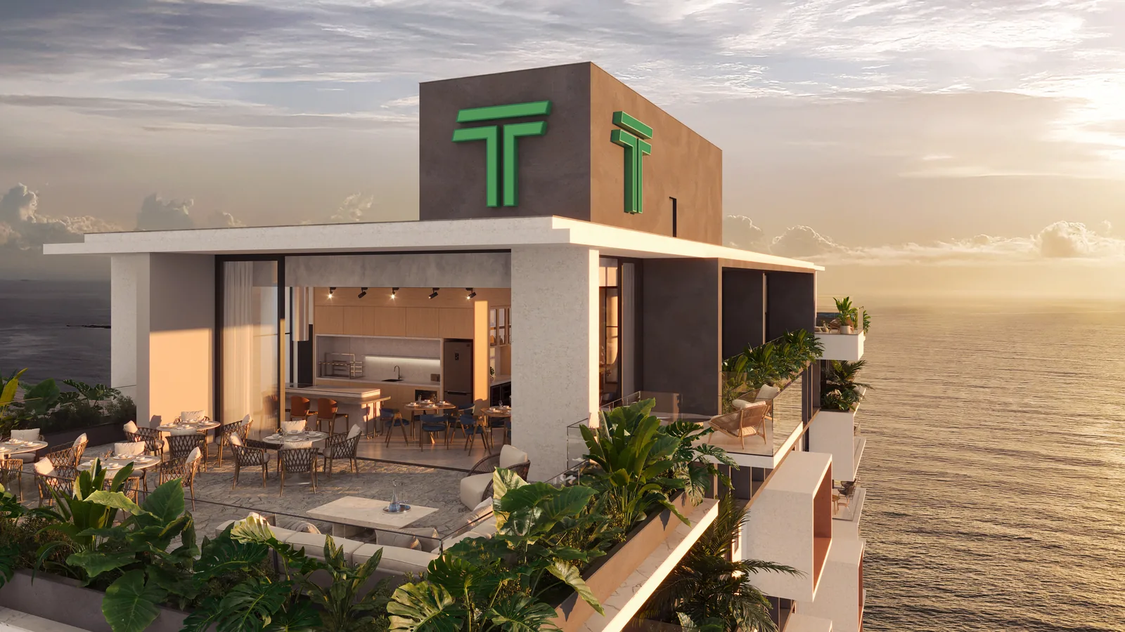 O pavimento de lazer no alto da torre ao fim da tarde, com o salão de festas aberto para o terraço, mesas postas, cozinha ao fundo e o mar nos dois lados